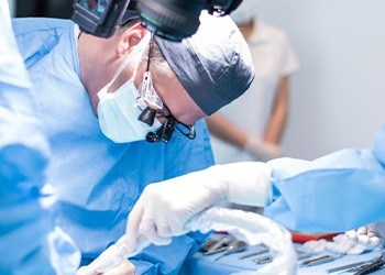 an oral surgeon performing dental implant placement
