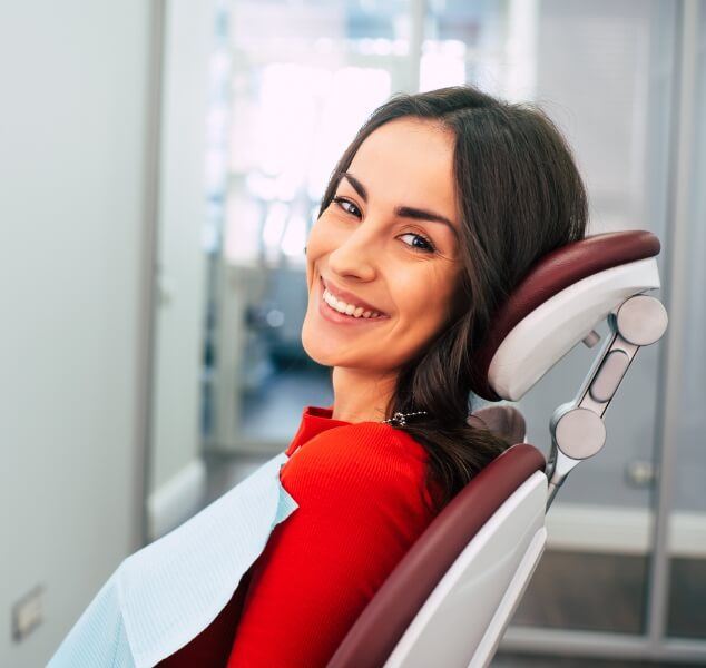 Woman smiling in dental chair at dental office in Springfield