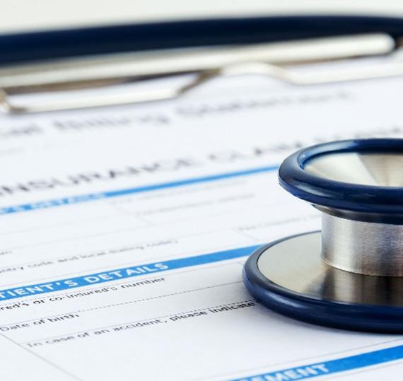 Stethoscope on top of a health insurance form
