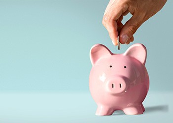 Placing a coin in a piggy bank