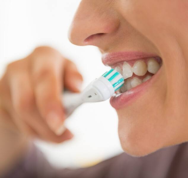 Close up of person brushing their teeth