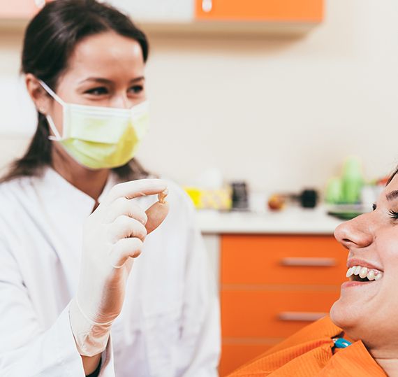 a patient smiling after her tooth extraction  