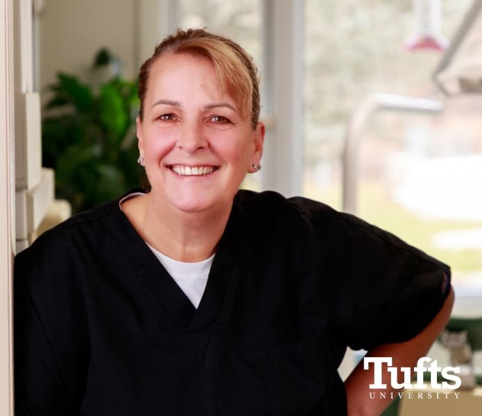 Springfield Massachusetts dentist Doctor Laura Gramse smiling with Tufts University logo in lower right corner