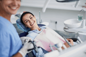 a person smiling while visiting their dentist